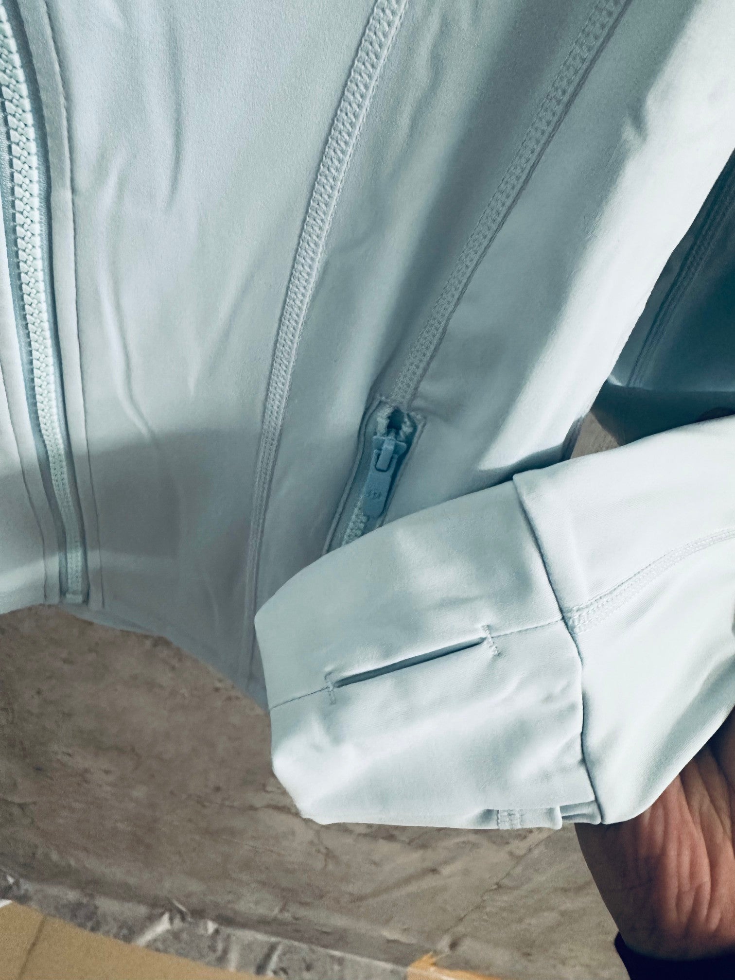 Ralph Lauren light blue zip-up jacket close-up of cuff and zipper pocket