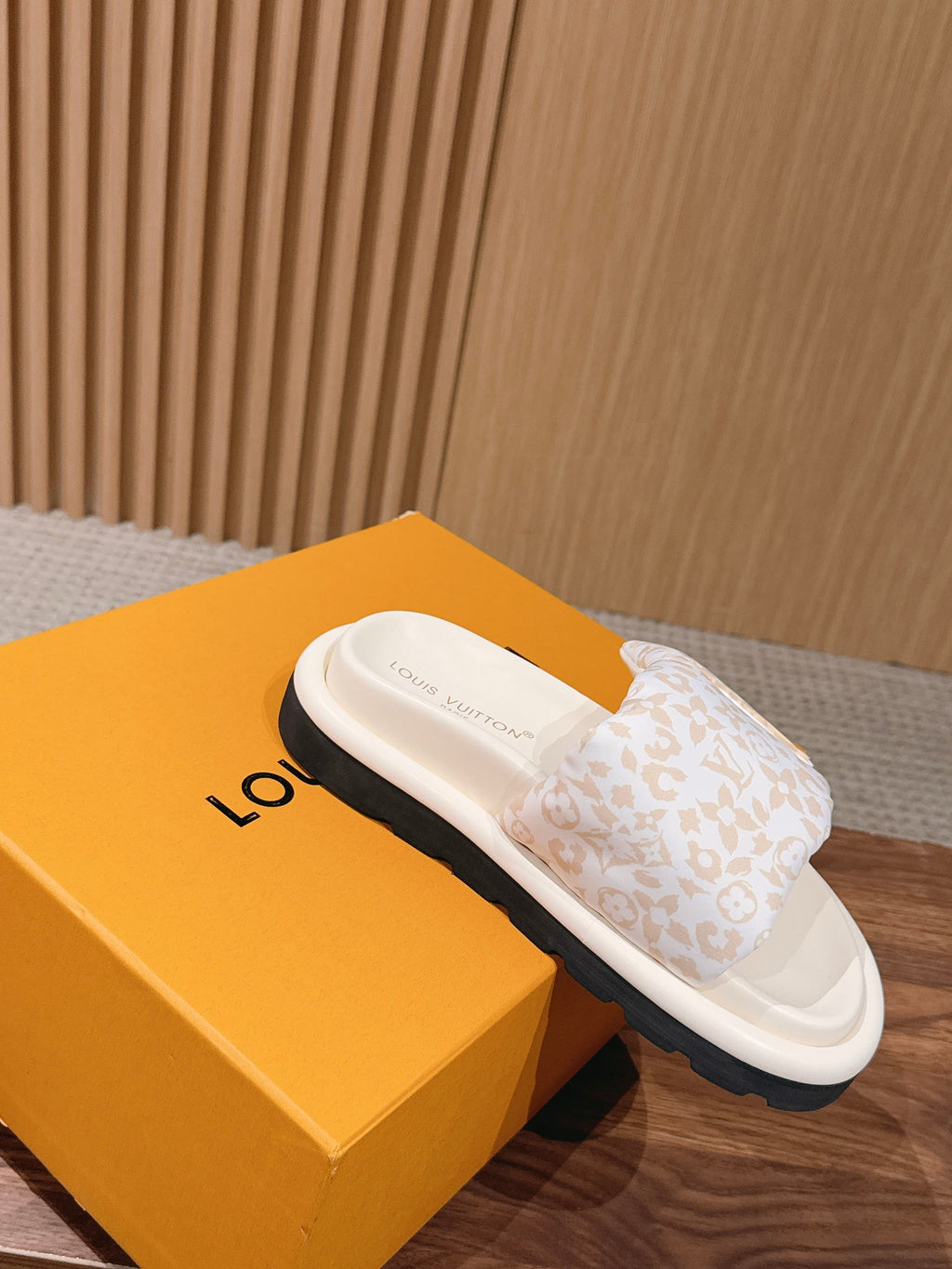 White Louis Vuitton monogram slide sandals with cushioned footbed and strap