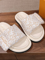 Pair of Louis Vuitton slide sandals, white monogram-patterned straps and white footbeds