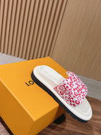 Louis Vuitton slide sandal with red monogram floral strap on white base, on gray sole