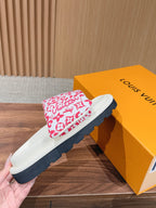 Pink floral logo-pattern slide sandal held near a yellow Louis Vuitton shoebox