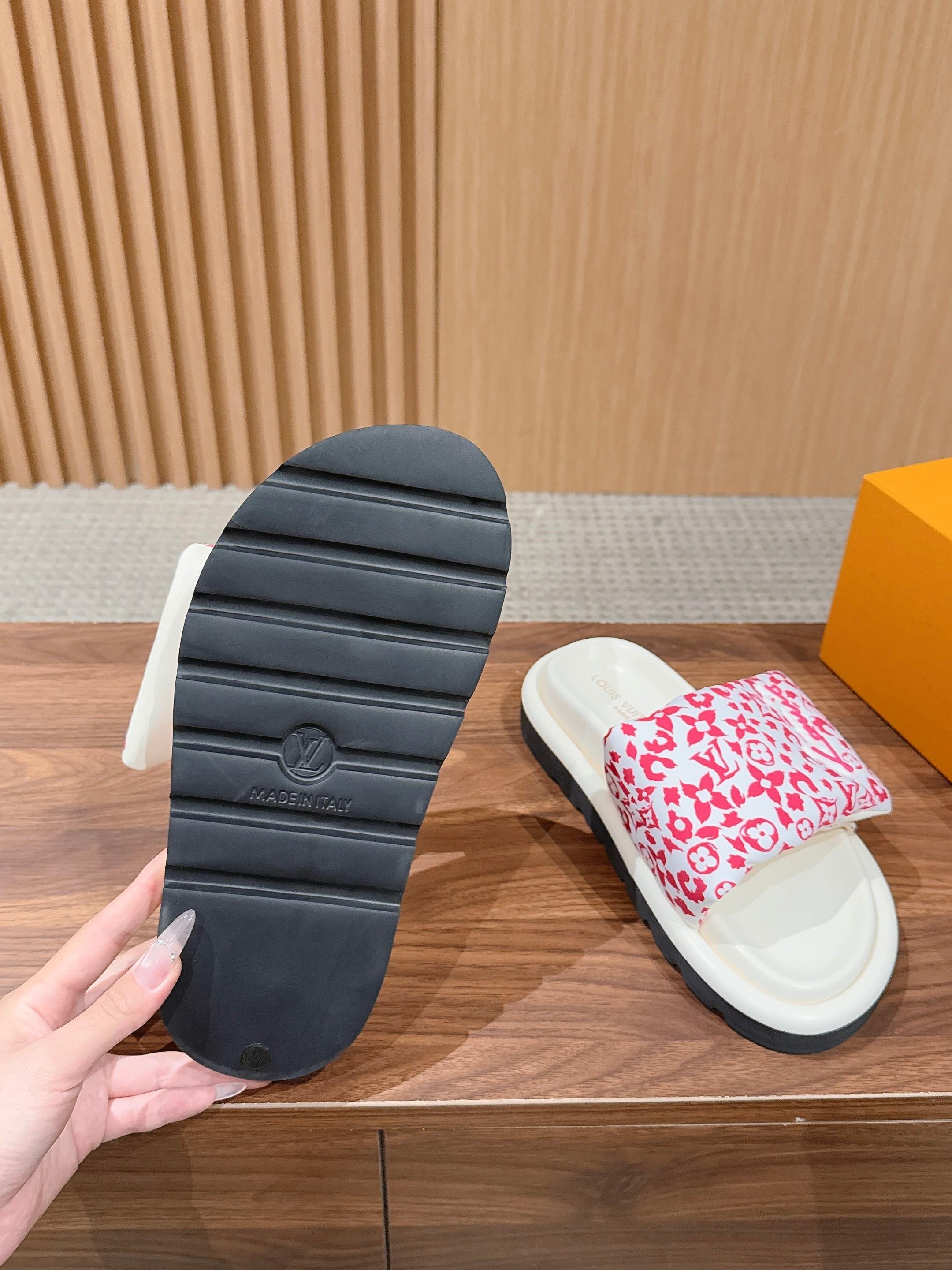 Louis Vuitton slide sandal outsole view with ridged gray rubber and red floral strap upper