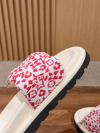 Louis Vuitton slide sandal, close view of red monogram floral upper on white footbed
