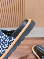 Louis Vuitton slide sandal side view: blue patterned upper with tan midsole and black base