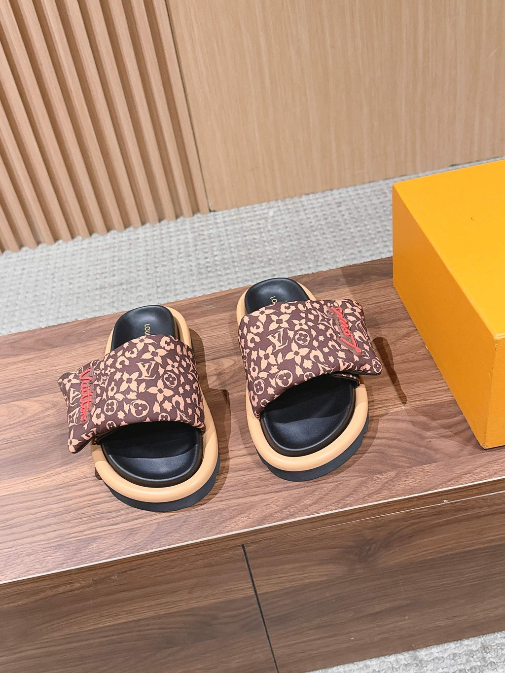 Louis Vuitton patterned slide sandals with cushioned black footbed and beige sole