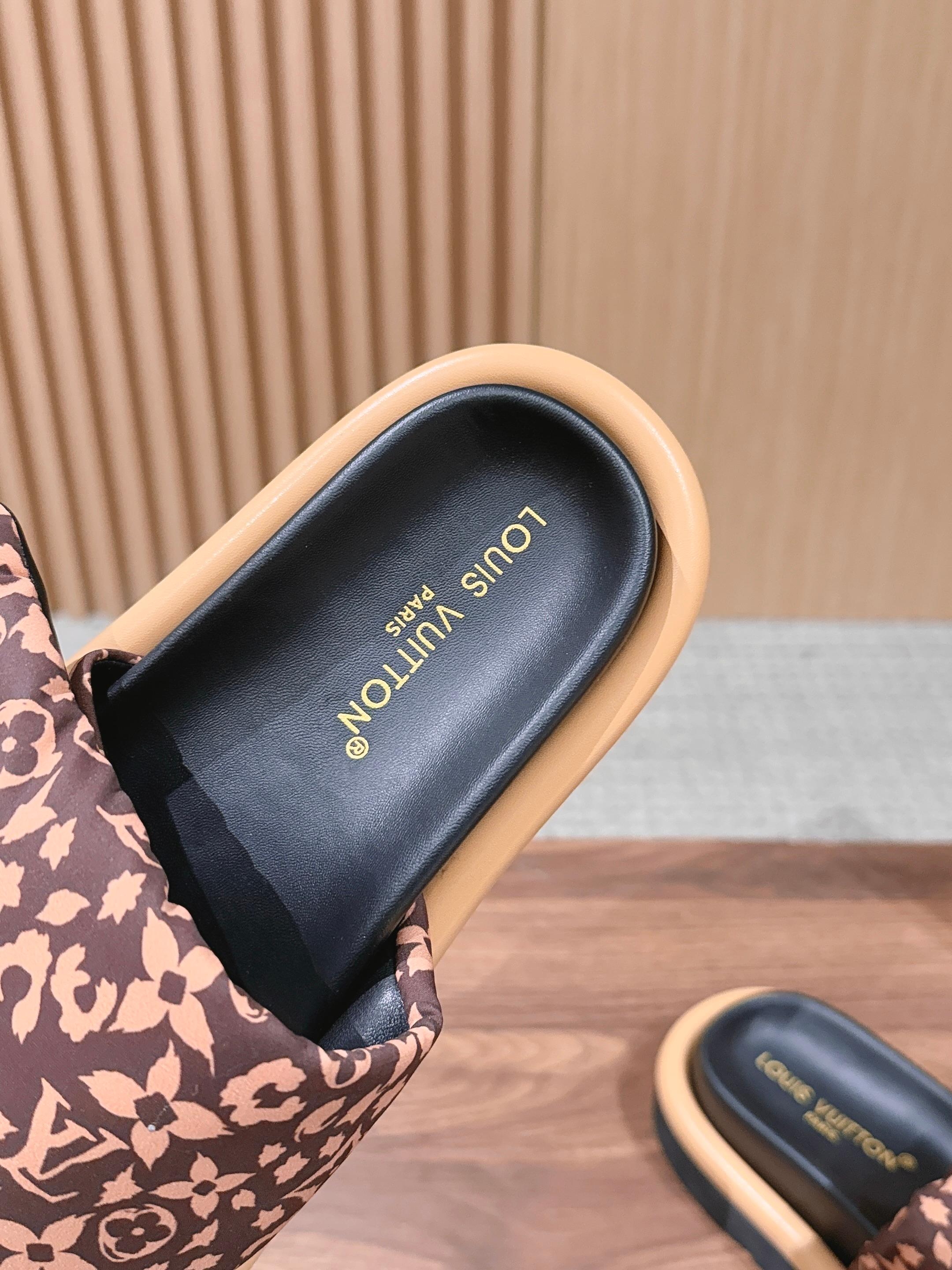 Close-up of slide sandal insole text on black footbed with printed strap lining.