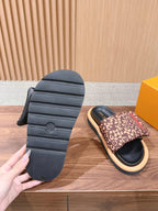 Outsole detail of slide sandals with tread grooves, plus one patterned strap sandal.
