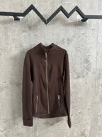 Brown zip-up jacket with stand collar and gold-tone front zipper, hanging on a rack