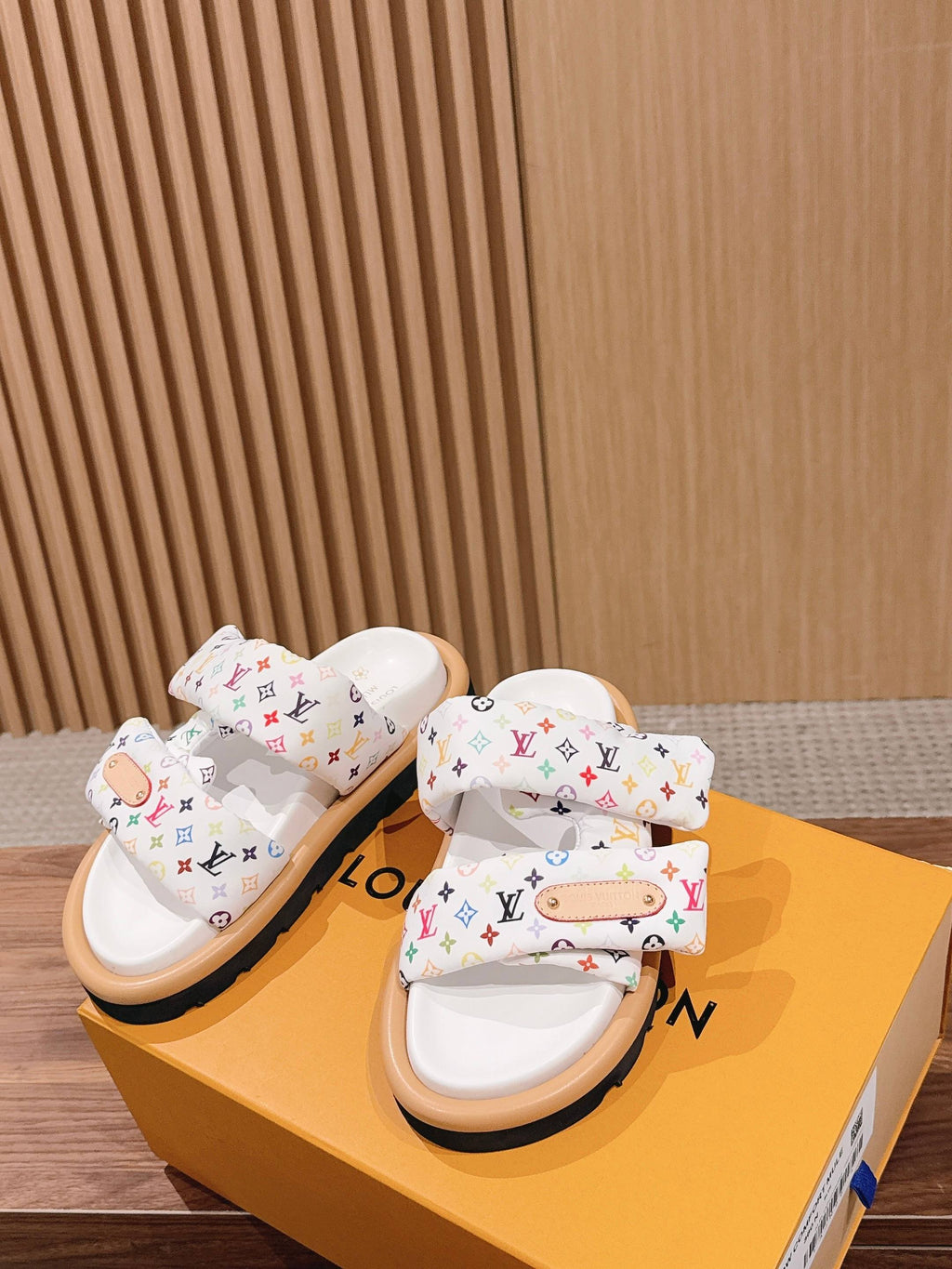 Louis Vuitton monogram slide sandals on orange box, white upper with multi-color logos