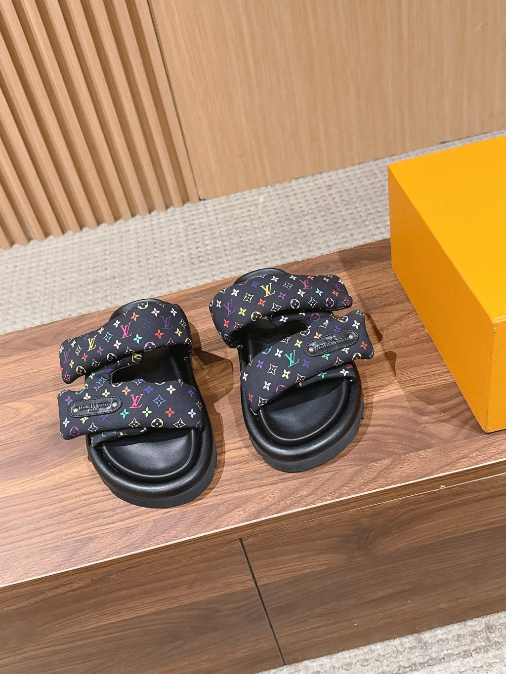 Louis Vuitton slide sandals in black with multicolor logo strap