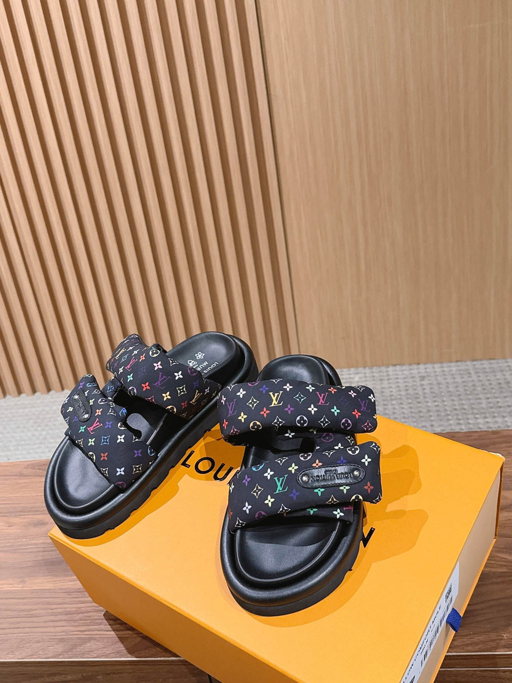 Slide sandals with multicolor logo-print straps and black sculpted sole