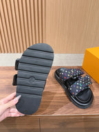 Slide sandals heel view with black outsole and multicolor logo strap