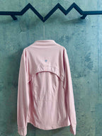 Light pink zip-up jacket with stand collar and small back logo