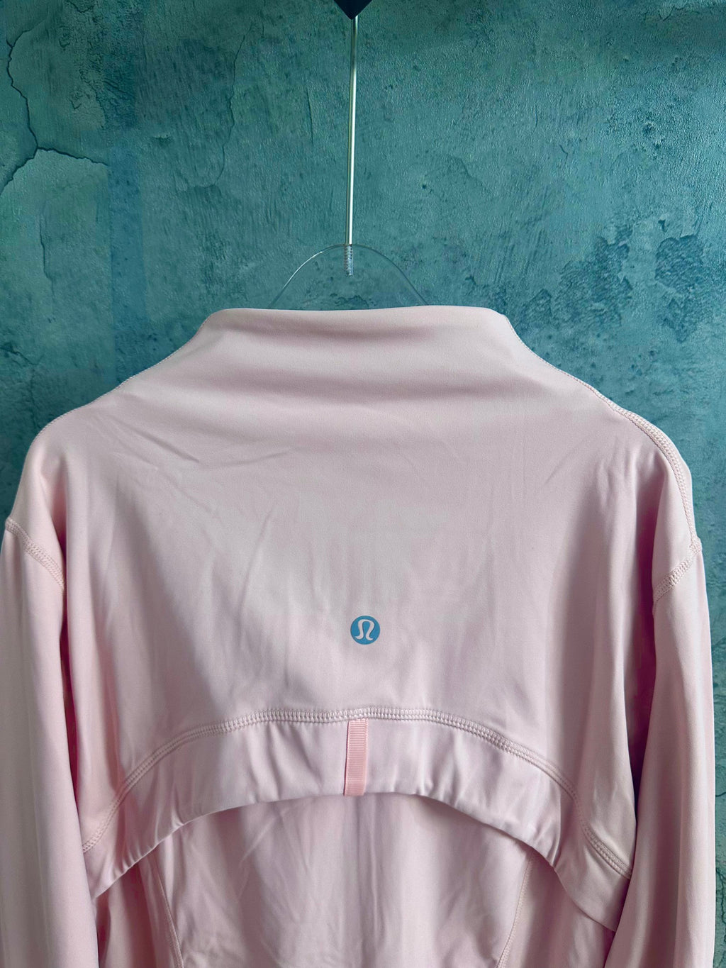 Light pink zip-up jacket back with stand collar and small logo