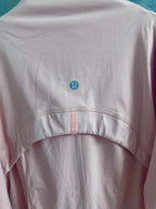 Light pink zip-up jacket back with small logo at center