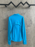Light blue zip-up jacket with high neck and back yoke detail