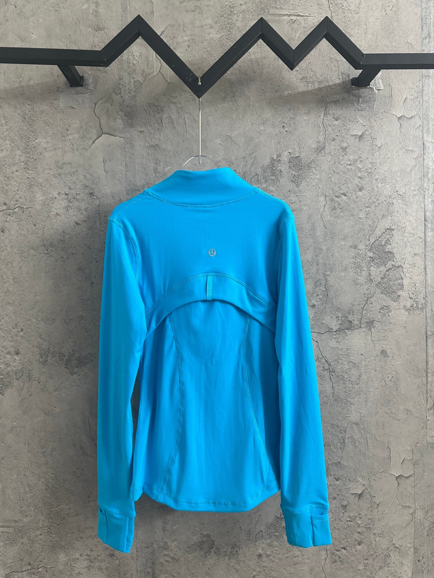 Light blue zip-up jacket with high neck and back yoke detail