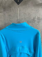 Light blue jacket back view with small chest logo and high neck