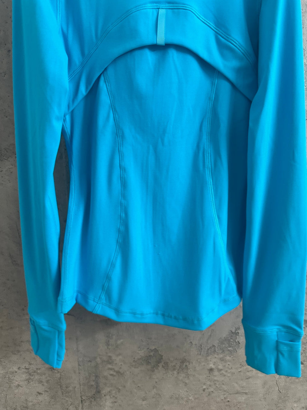 Light blue jacket back with curved yoke seams and stand collar