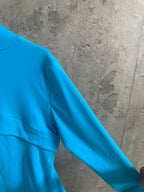 Light blue jacket shoulder and sleeve with stitched seam detail