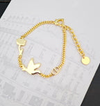 Gold-tone charm bracelet with bird motifs, chain links and clasp detail