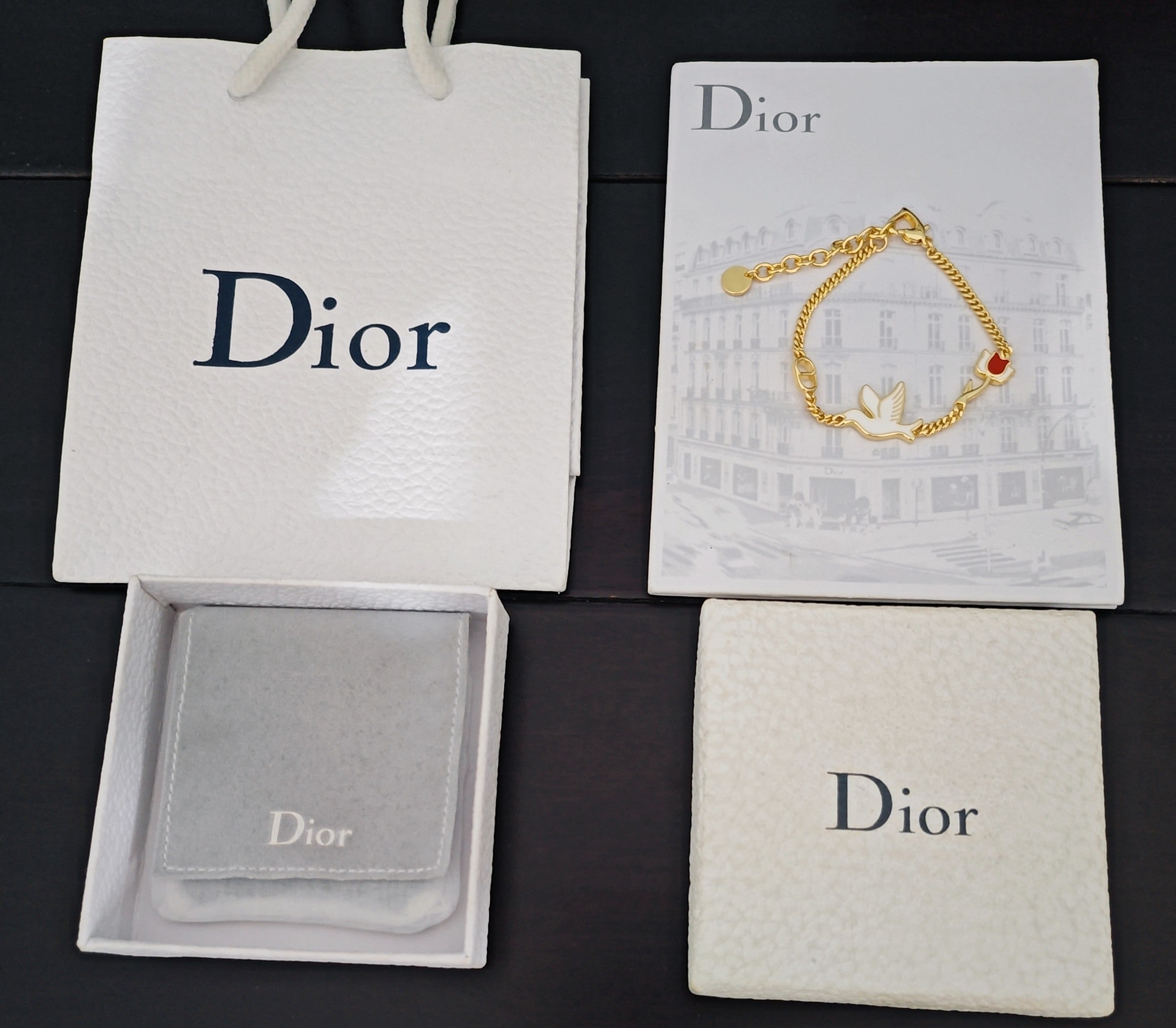Dior gift set packaging with shopping bag and jewelry box holding bracelet