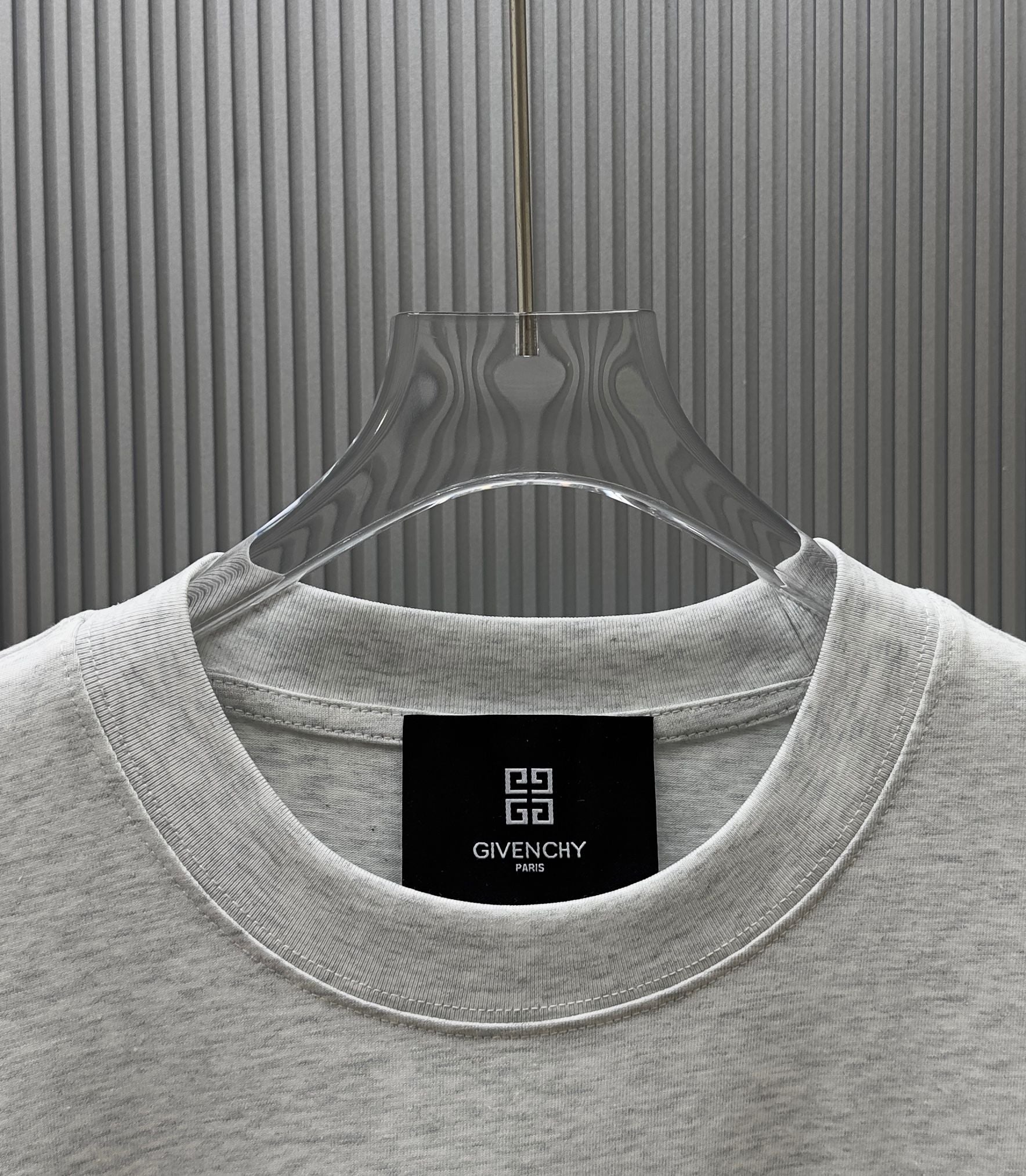 Light gray Givenchy crewneck T-shirt neckline close-up with inner tag