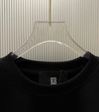 Black crew-neck T-shirt neckline detail with small logo label