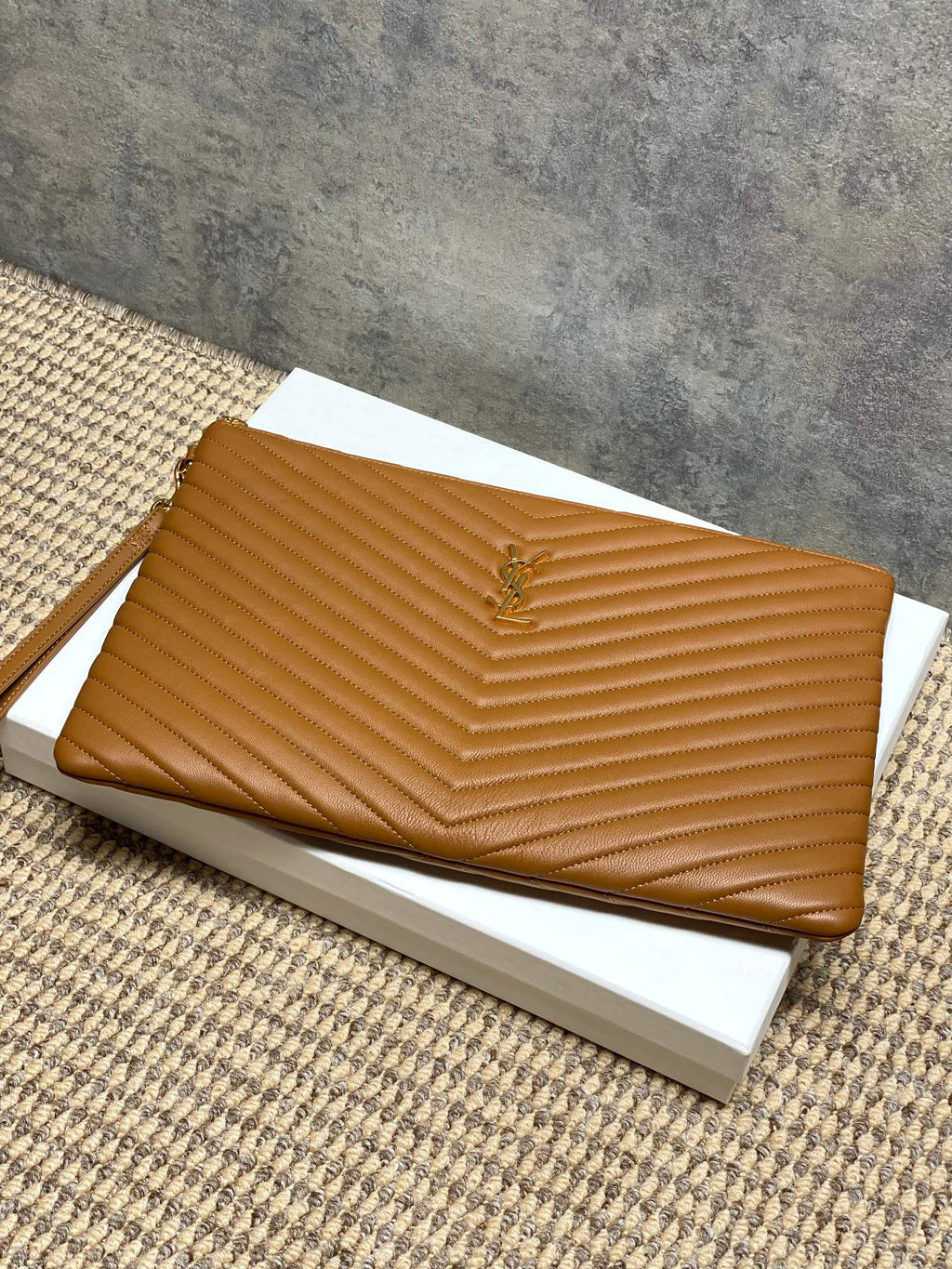 Tan chevron quilted clutch bag with gold-tone zipper and YSL emblem