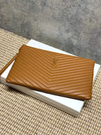 Tan chevron quilted clutch bag with gold-tone zipper and YSL emblem
