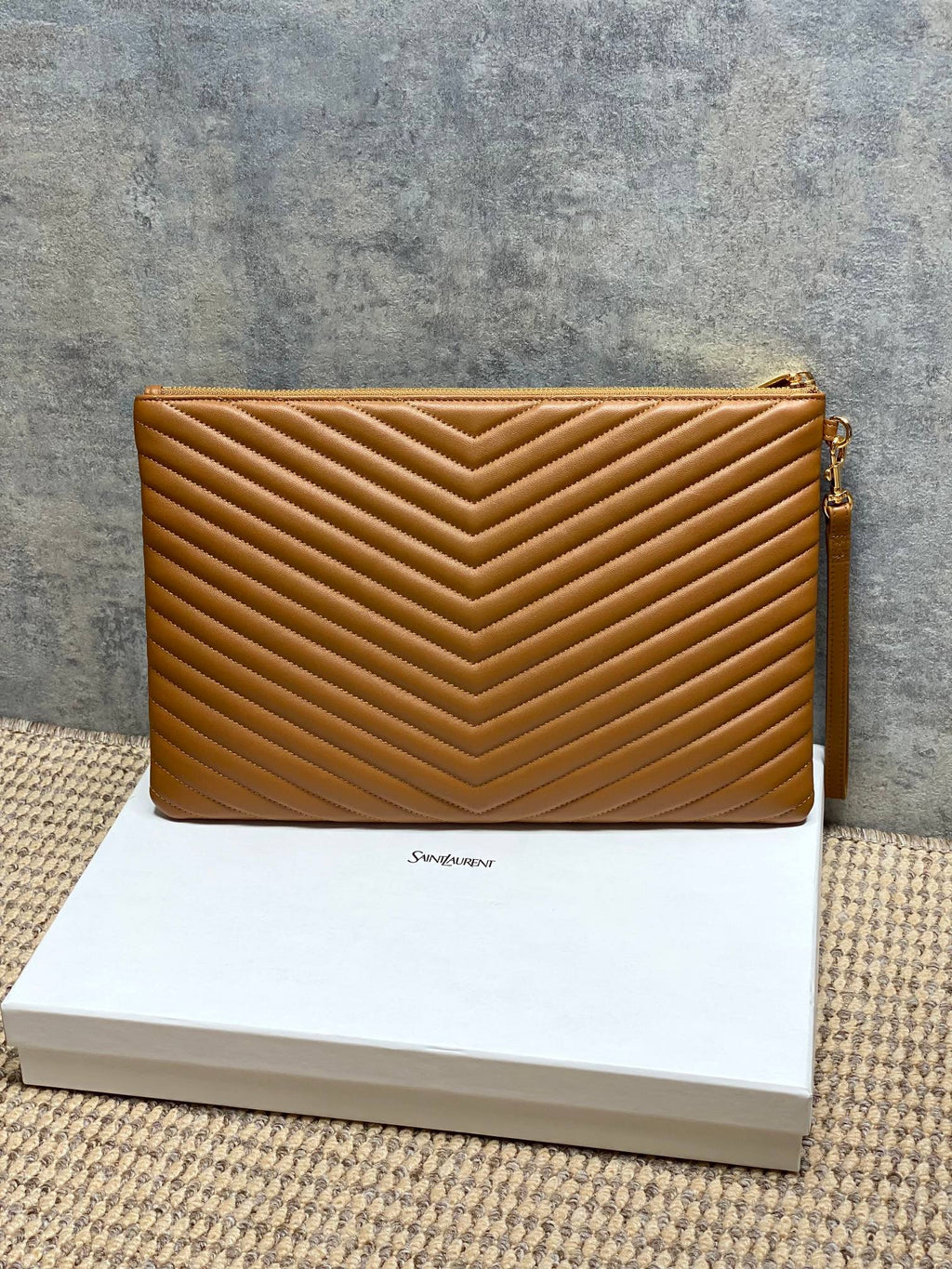 Tan quilted small clutch bag with gold-tone top zip and side hardware