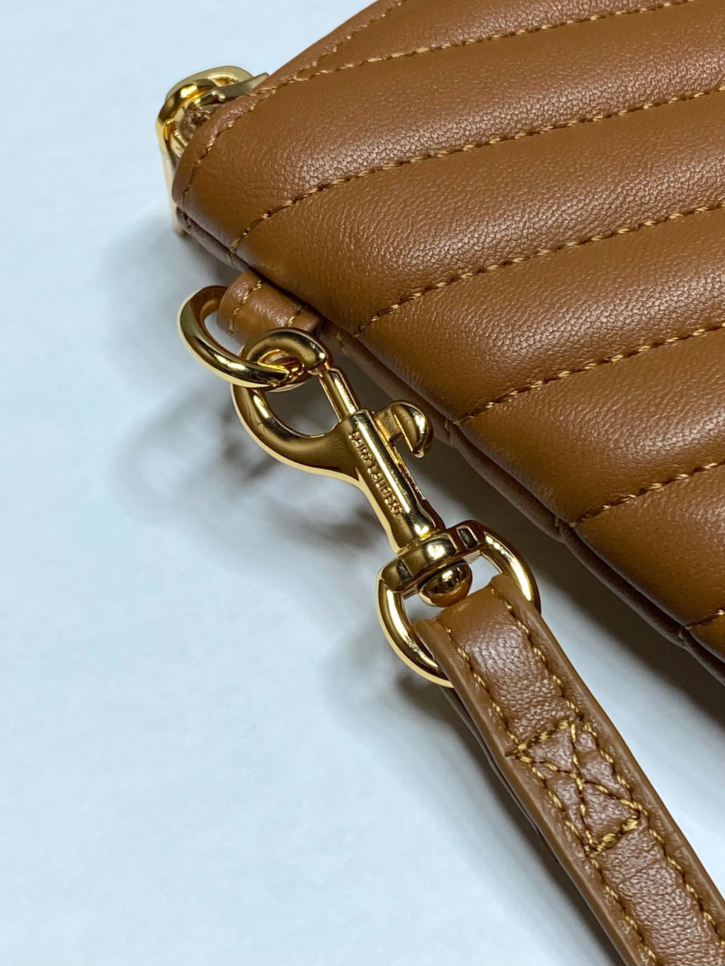 Tan leather strap with gold-tone clasp hardware