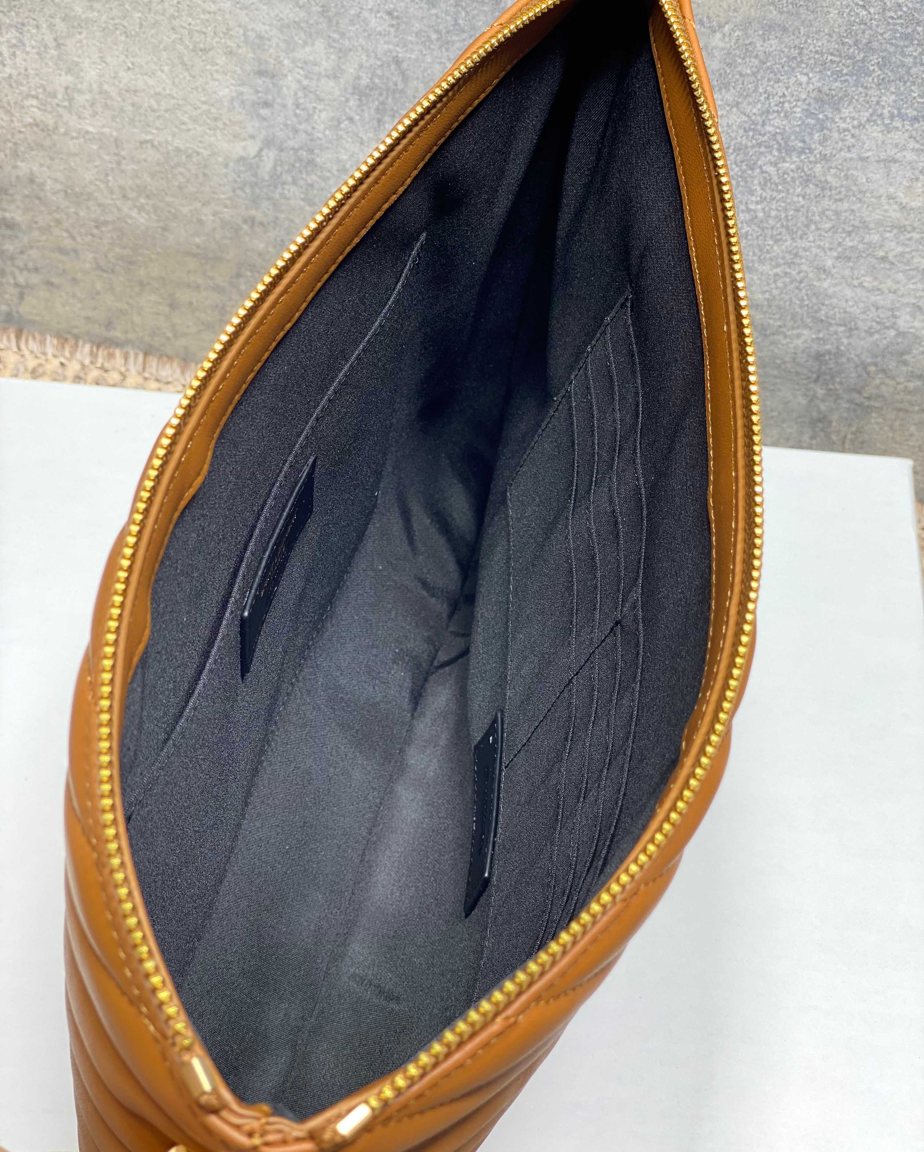Open tan clutch bag with dark interior lining and quilted panel