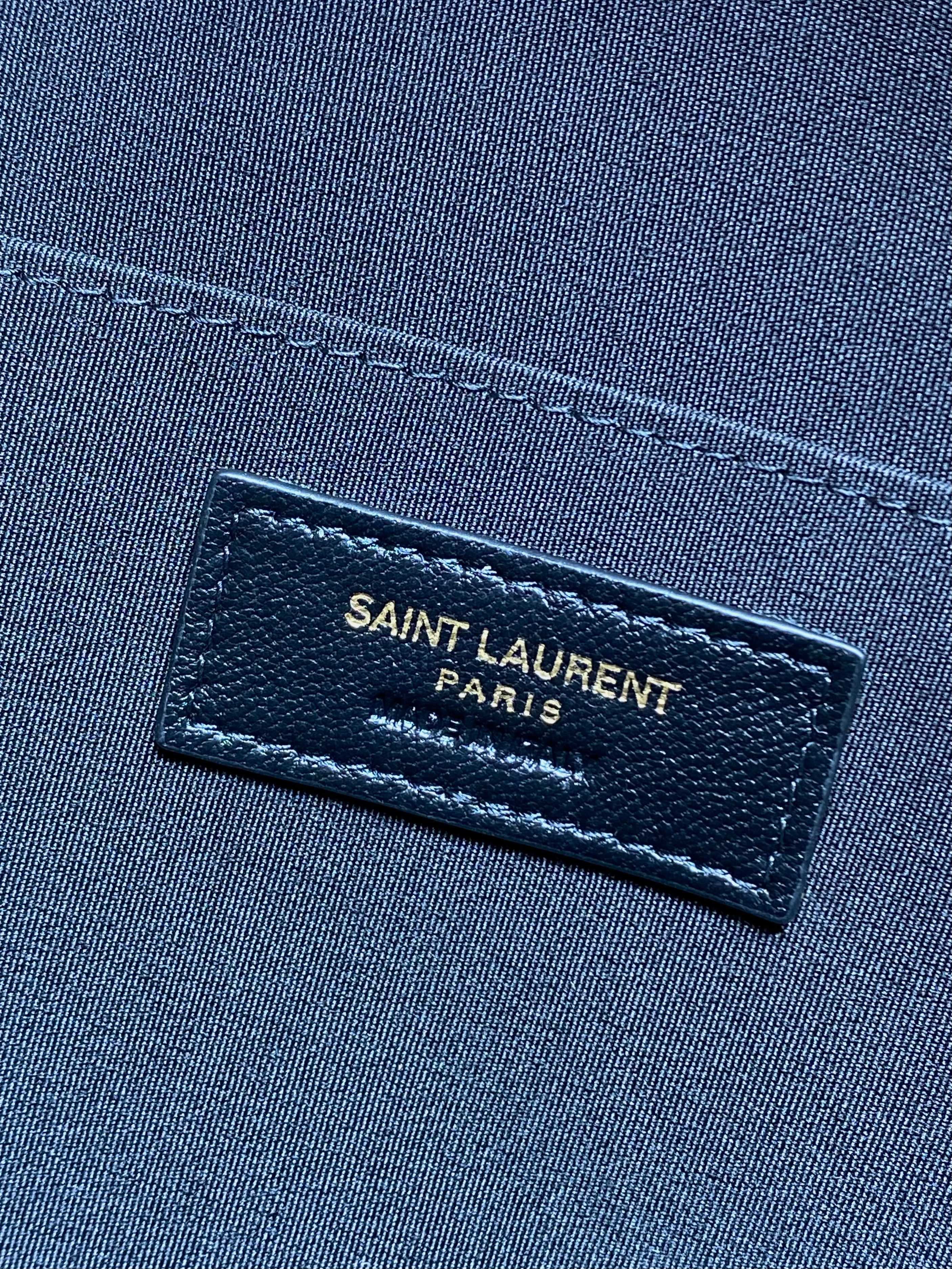 SAINT LAURENT PARIS leather label on dark fabric interior lining
