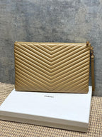 Quilted clutch bag with gold tone chevron stitching and gold zipper hardware