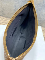 Dark fabric interior view of YSL small bag with open top and gold zipper trim.