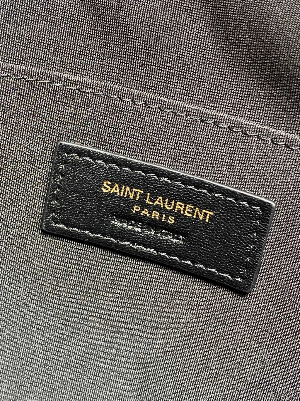 SAINT LAURENT Paris fabric label on dark interior lining