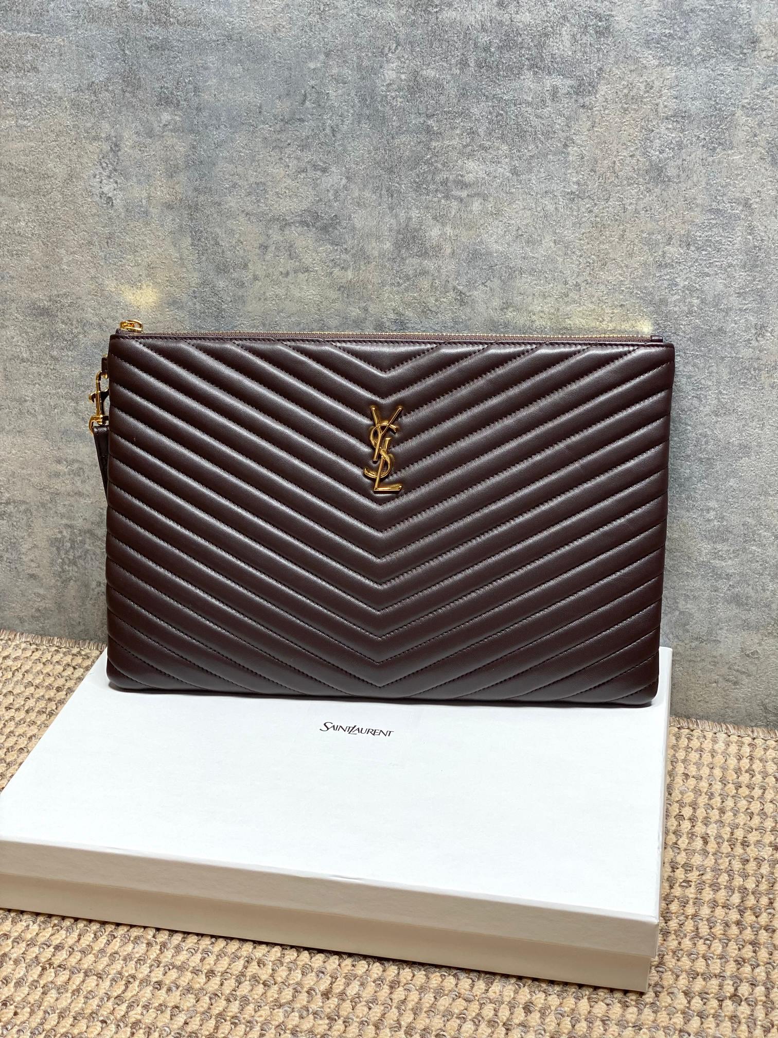 Dark brown quilted leather bag with gold YSL logo and chevron stitching