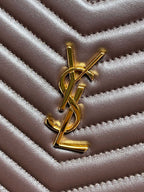 Gold YSL logo on dark brown quilted leather with chevron stitching