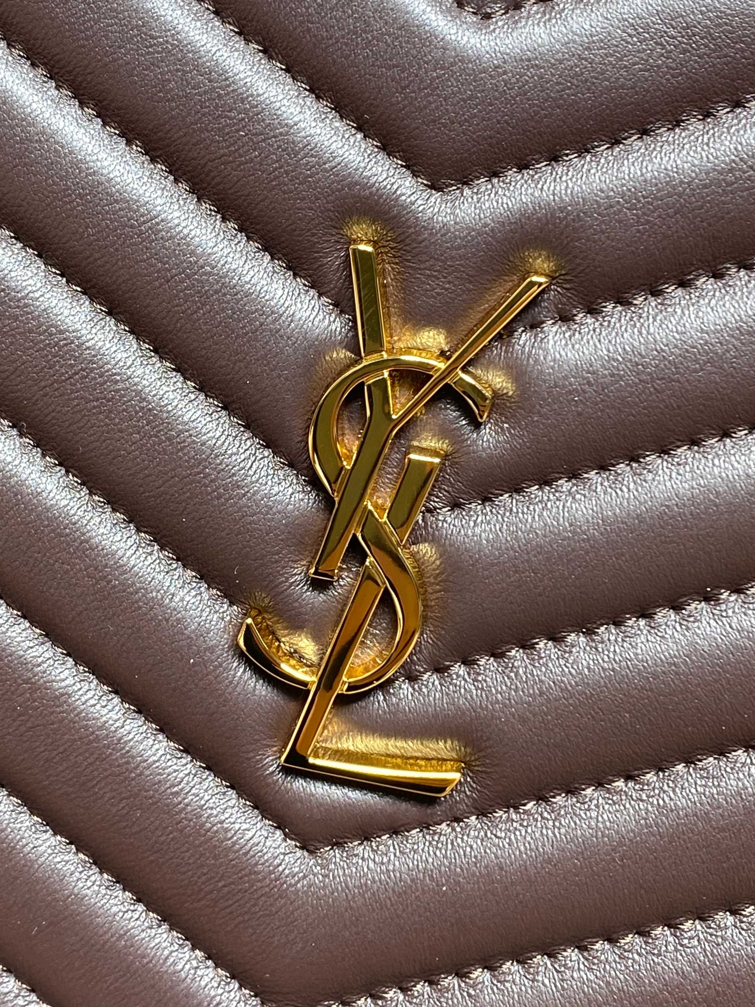 Gold YSL logo on dark brown quilted leather with chevron stitching