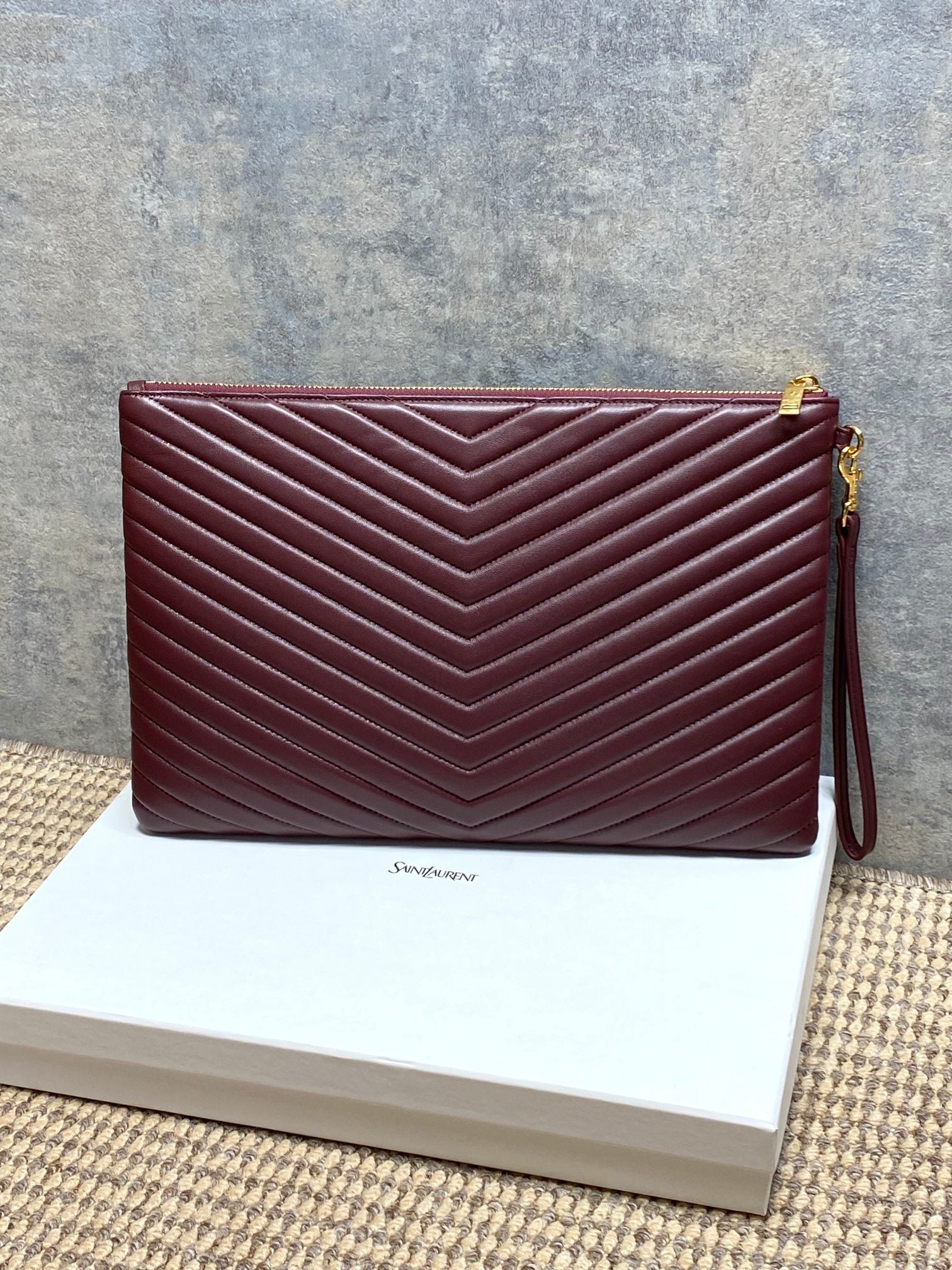 Women’s YSL small quilted bag in burgundy with gold logo and side view
