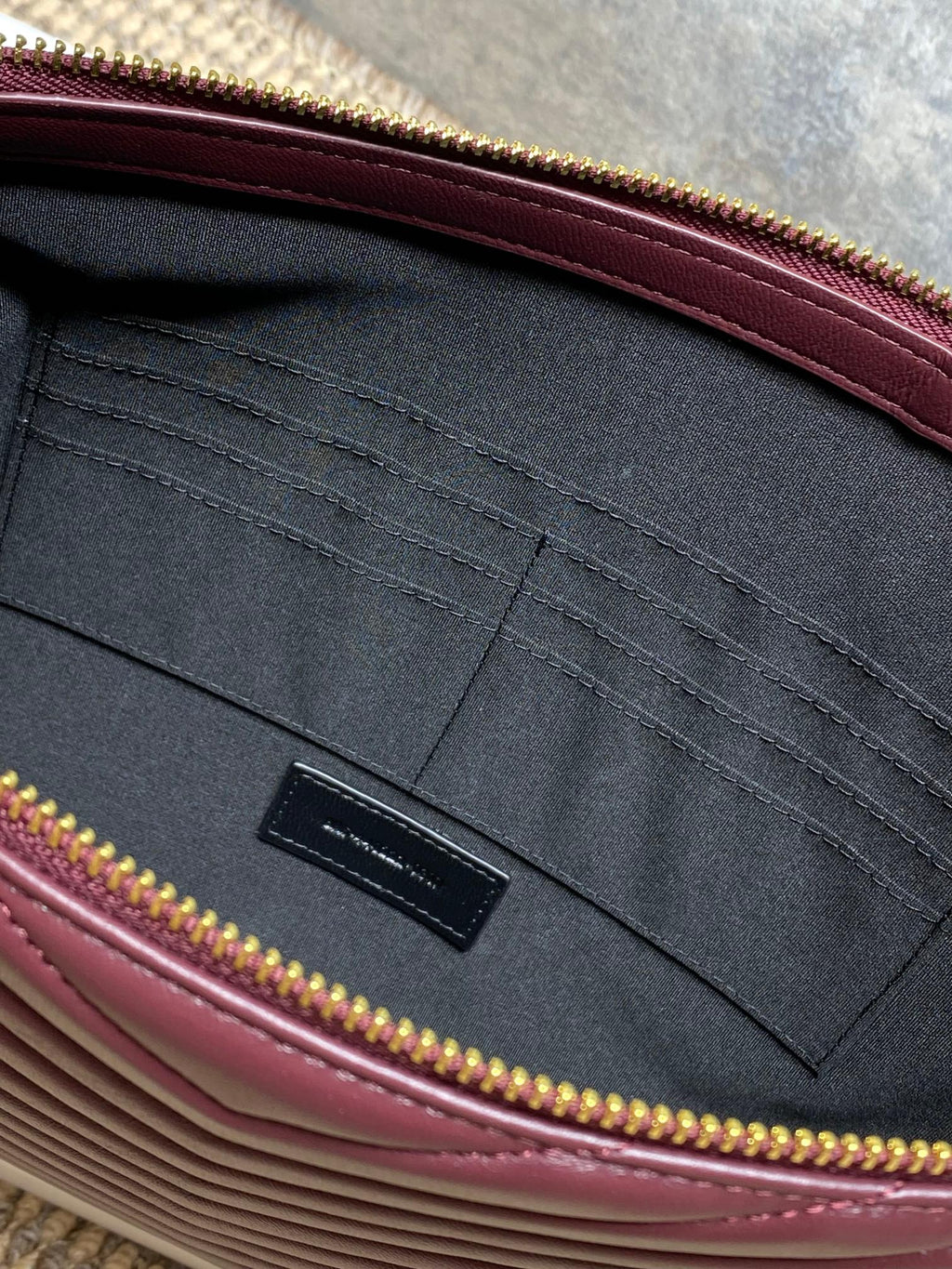 YSL quilted clutch interior with black pocket and burgundy trim