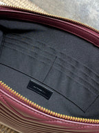 YSL quilted clutch interior with black pocket and burgundy trim