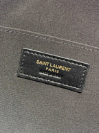 SAINT LAURENT PARIS label on dark interior fabric of YSL bag