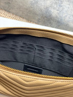 YSL bag interior with dark lining and gold zipper edge, tan chevron exterior