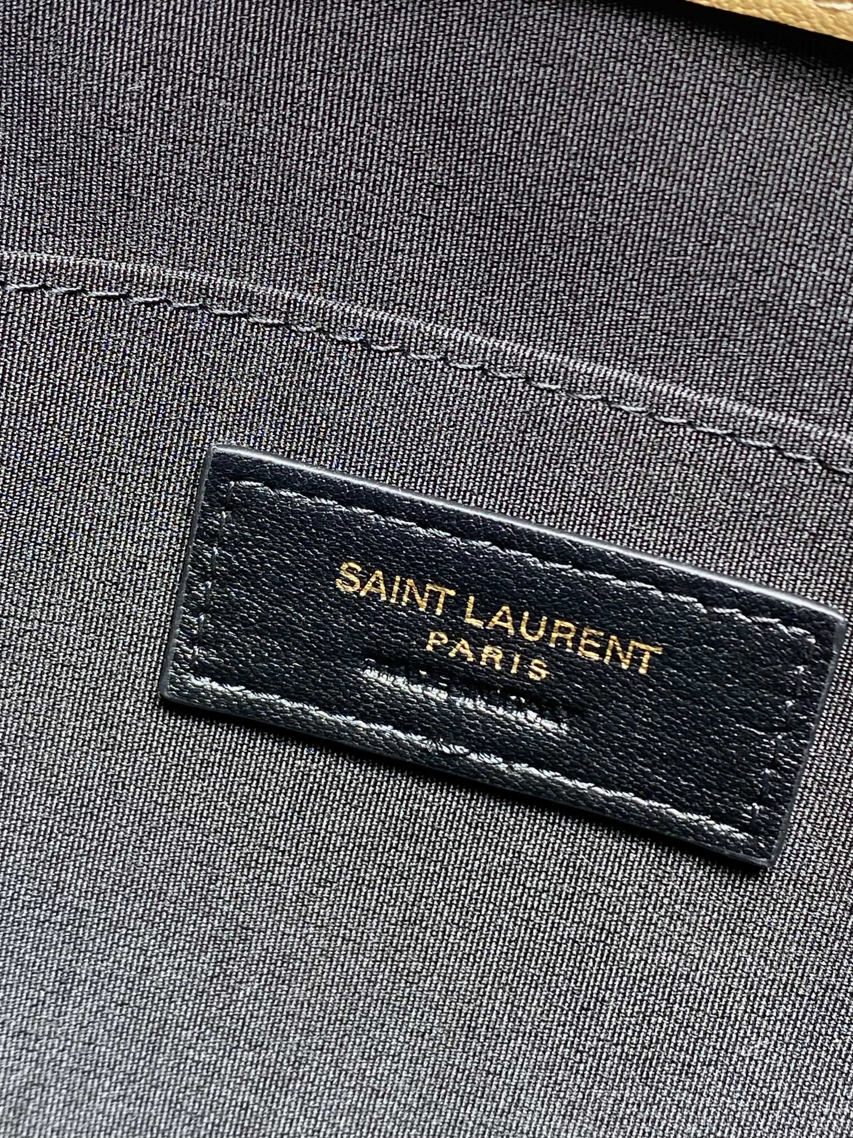 YSL Paris logo label on dark fabric lining inside tan bag