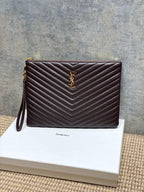 YSL small dark brown quilted handbag with chevron pattern, front YSL logo and wrist strap