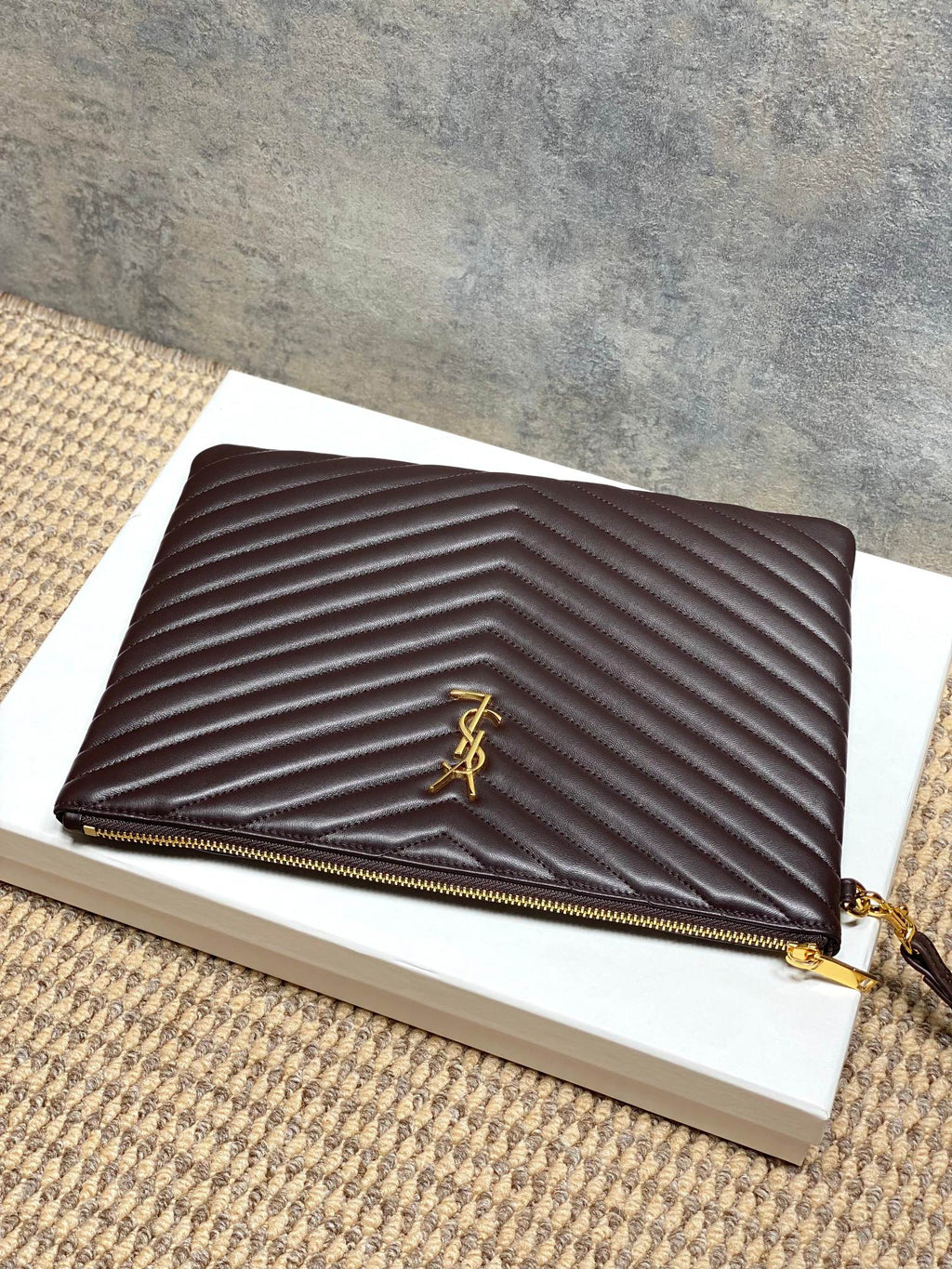 YSL small dark brown quilted handbag with front YSL logo, zip closure, and gold trim