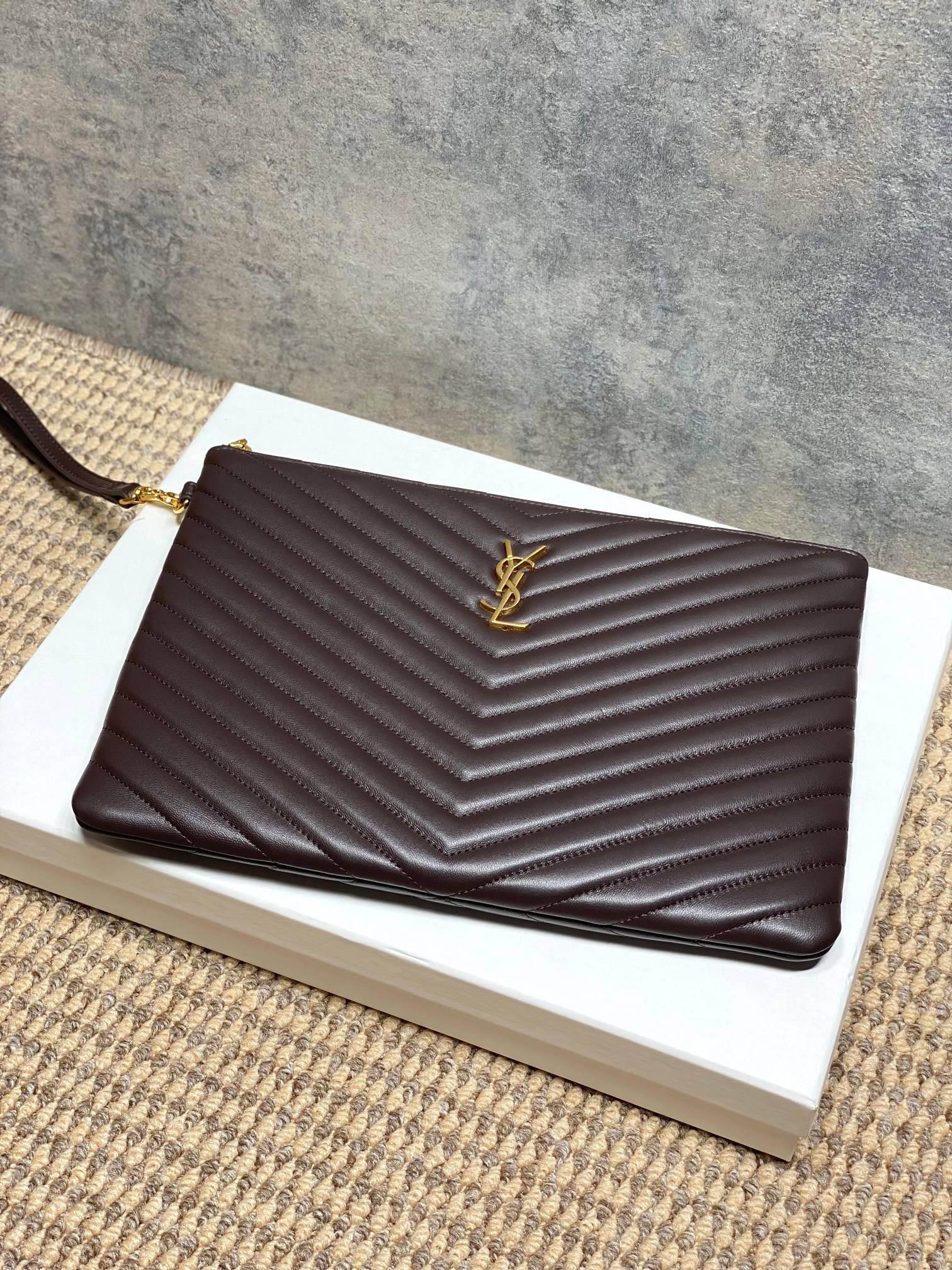 YSL small dark brown chevron quilted handbag with YSL logo on front and top edge
