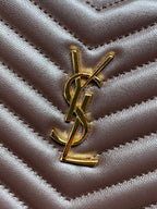 Gold YSL logo emblem on chevron-quilted dark leather